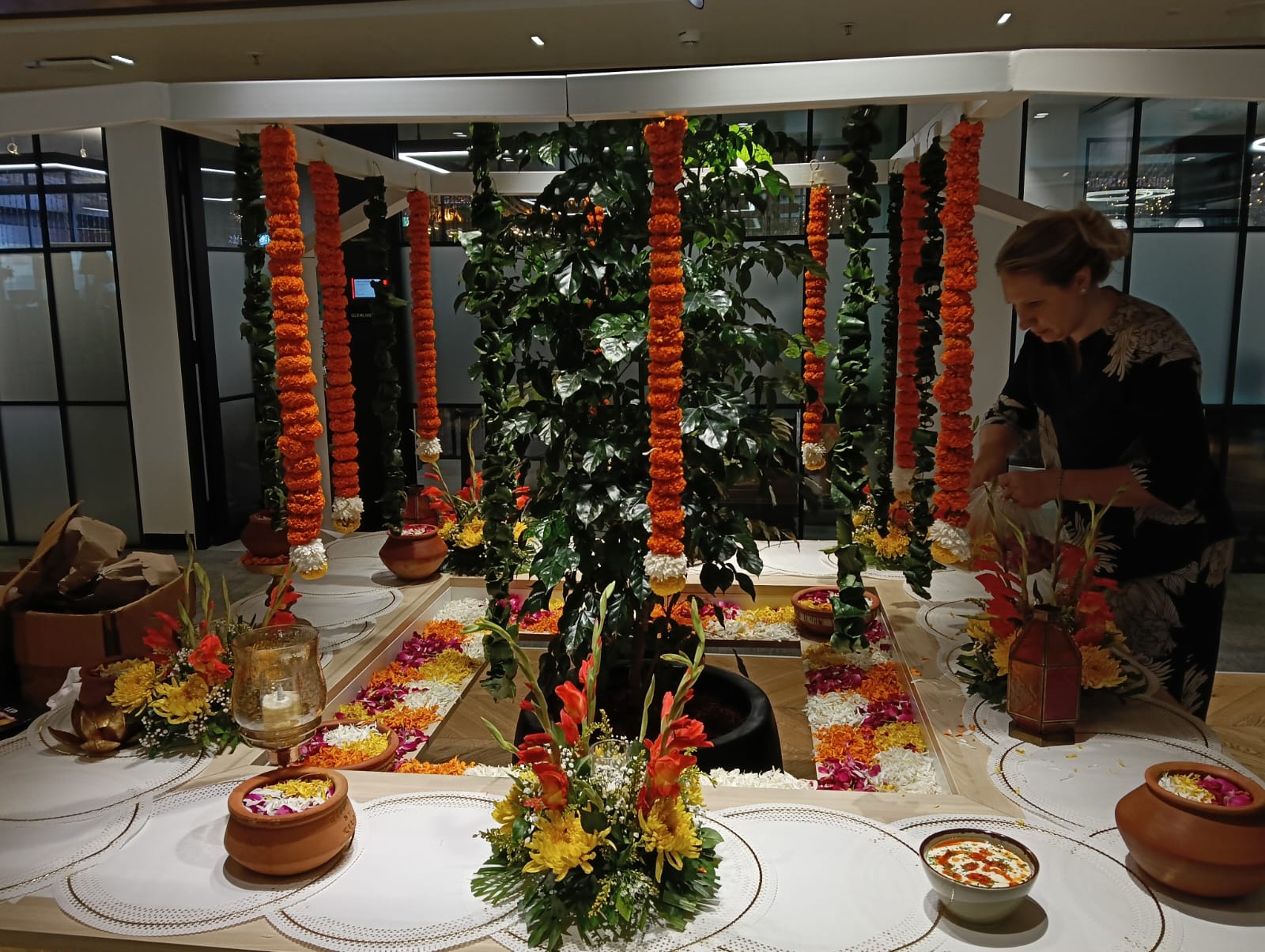 Marigold mandap setup with flowers and urlis