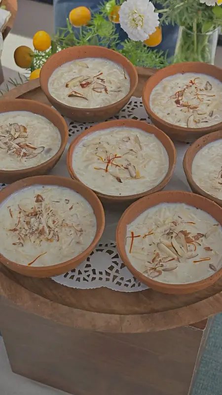 Saffron kheer served in earthen clay pots with almond garnish